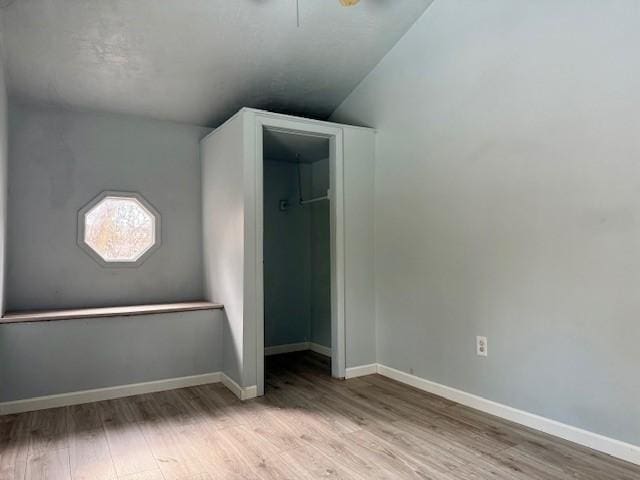 unfurnished bedroom with ceiling fan and light hardwood / wood-style flooring