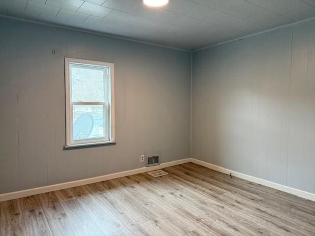 spare room featuring light hardwood / wood-style floors