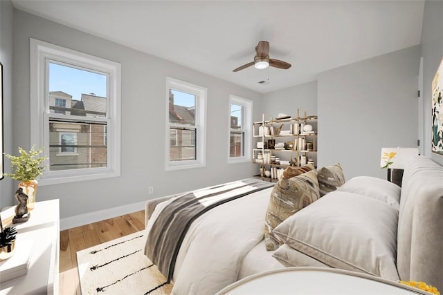 bedroom with ceiling fan and wood-type flooring