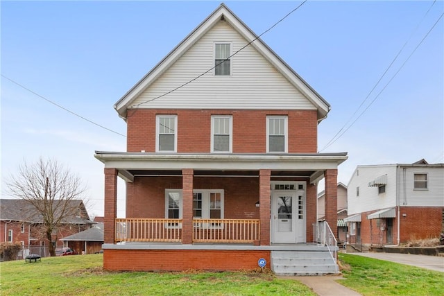 view of property with covered porch and a front lawn