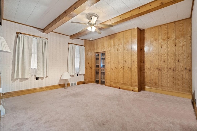 carpeted spare room with beam ceiling and ceiling fan