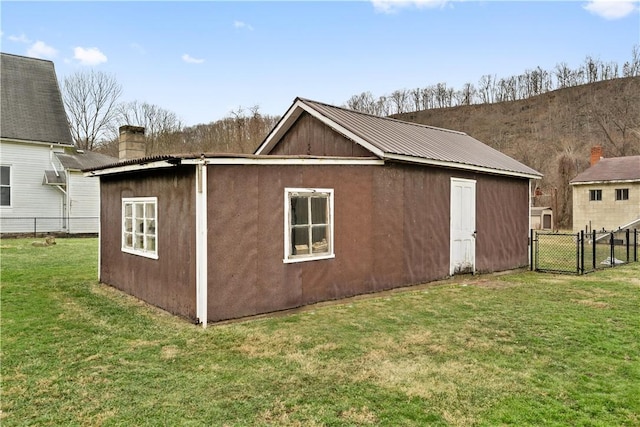 view of outdoor structure featuring a lawn