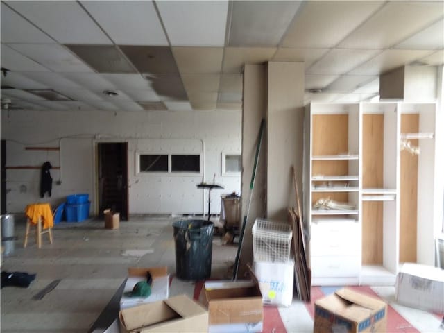 basement featuring hardwood / wood-style floors and a drop ceiling