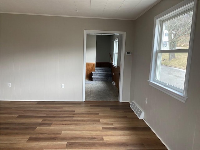 spare room with crown molding and dark hardwood / wood-style floors