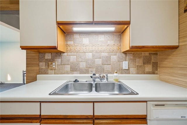 kitchen featuring white cabinetry, dishwasher, sink, and backsplash
