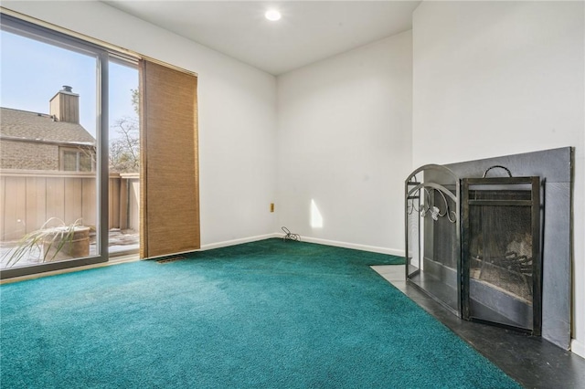 unfurnished living room featuring dark colored carpet