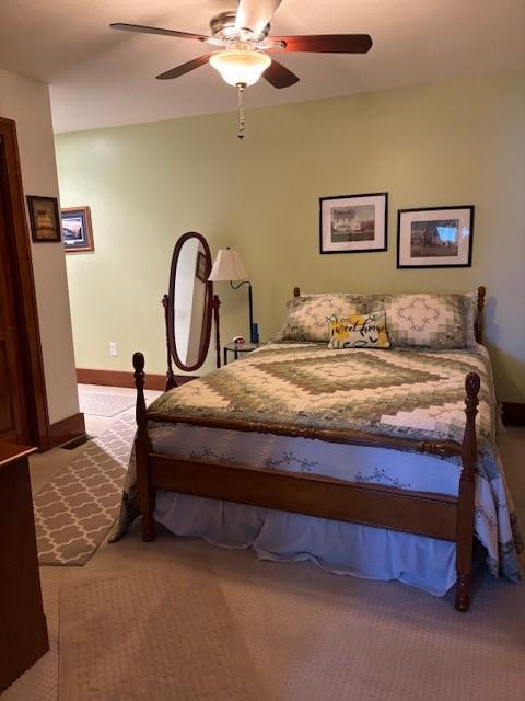 carpeted bedroom with ceiling fan