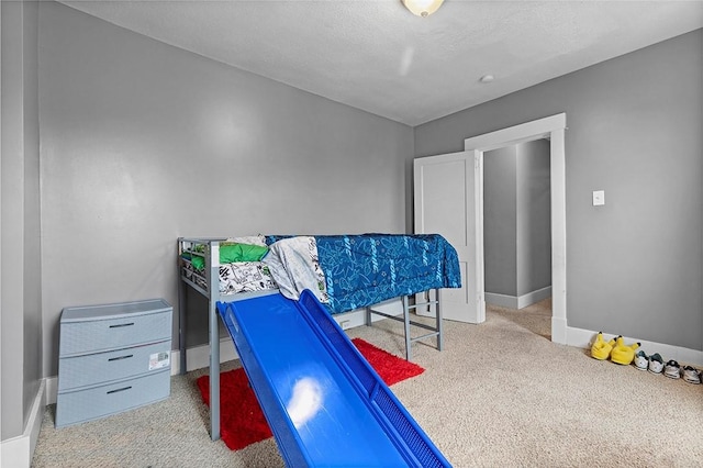 carpeted bedroom with a textured ceiling