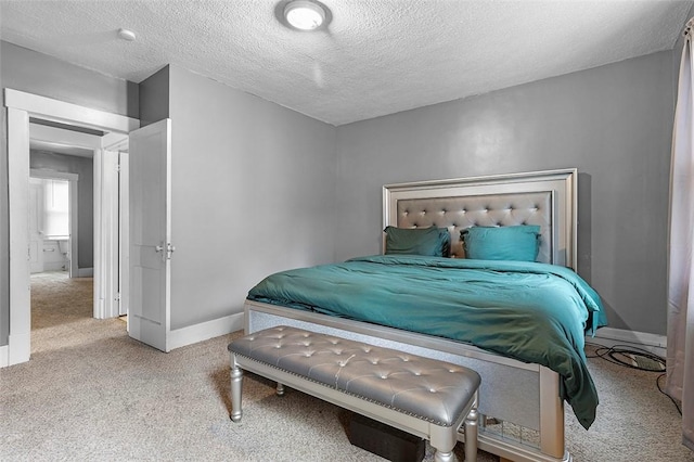 bedroom featuring light carpet and a textured ceiling