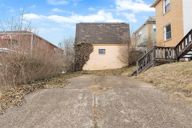 view of property exterior with an outdoor structure