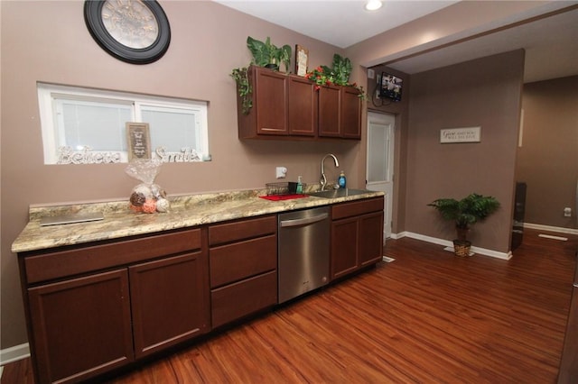 kitchen featuring dark wood-type flooring, stainless steel dishwasher, sink, and dark brown cabinets