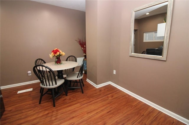 dining area with hardwood / wood-style floors