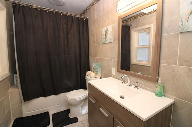 full bathroom with vanity, tile walls, shower / bath combination with curtain, and toilet