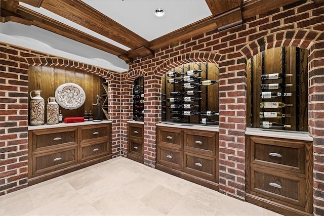 134 S Dr, Fox Chapel, PA 15238 - wine room featuring beam ceiling, light tile patterned floors, and brick wall