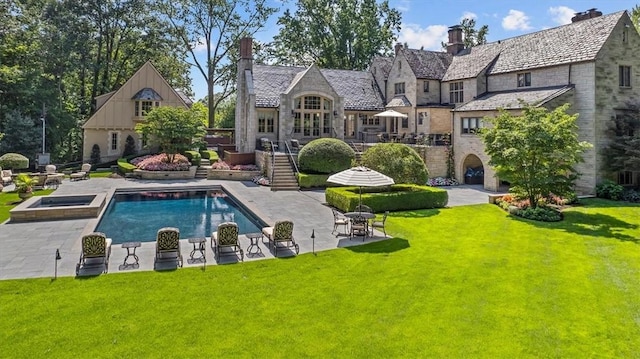 134 S Dr, Fox Chapel, PA 15238 - back of property featuring a high end roof, a lawn, stairway, a patio, and a pool with connected hot tub