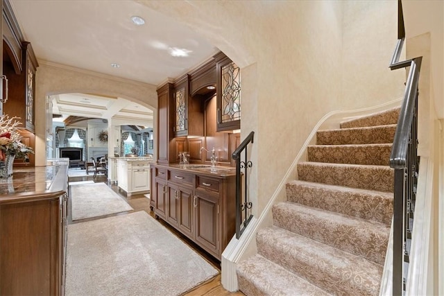 134 S Dr, Fox Chapel, PA 15238 - staircase with arched walkways, coffered ceiling, ornamental molding, beam ceiling, and wood finished floors