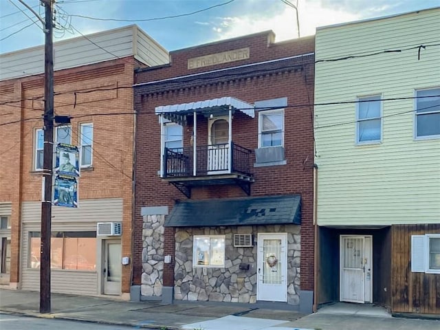 view of building exterior with a wall mounted AC