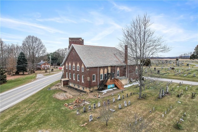 rear view of property featuring a yard