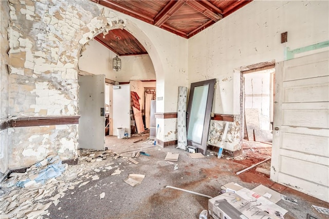 misc room featuring beam ceiling and a high ceiling