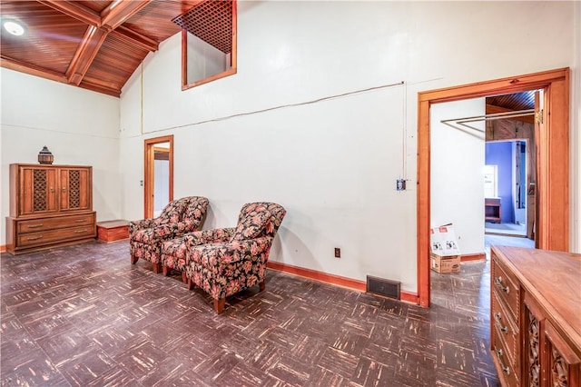 sitting room with wood ceiling and high vaulted ceiling