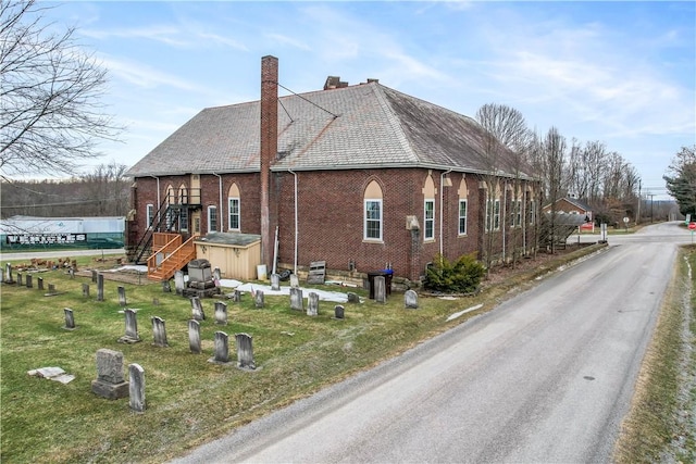 view of property exterior with a lawn