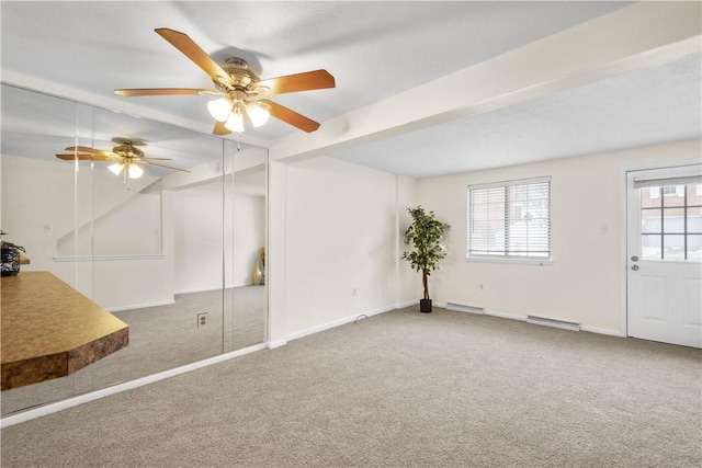 interior space with plenty of natural light, carpet flooring, beam ceiling, and baseboard heating