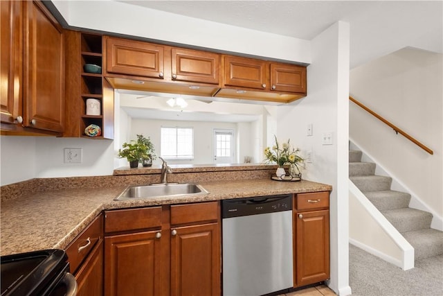 kitchen featuring dishwasher, sink, light colored carpet, and electric stove