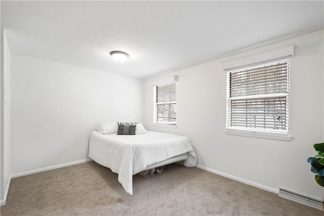 carpeted bedroom featuring baseboard heating