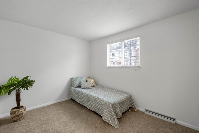 carpeted bedroom with a baseboard heating unit