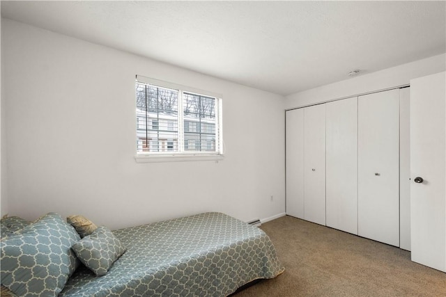 bedroom featuring light carpet and a closet