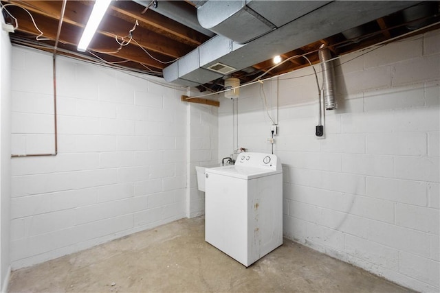 clothes washing area with sink and washer / dryer