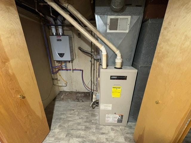 utility room with tankless water heater
