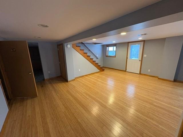basement with light hardwood / wood-style flooring