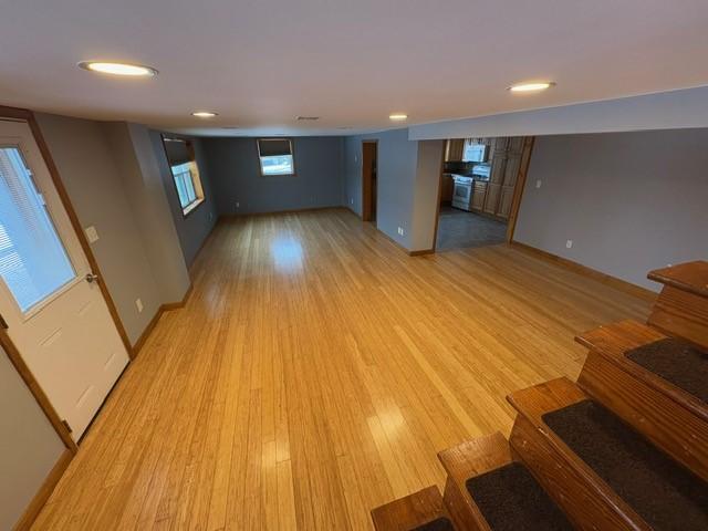 basement with light hardwood / wood-style flooring