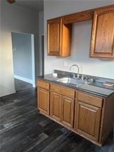 kitchen with sink and dark wood-type flooring