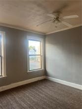 empty room with crown molding and ceiling fan