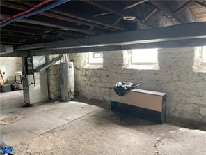 basement with gas water heater and heating unit