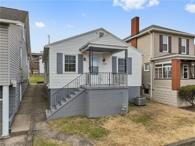 view of front of house featuring central AC and a front lawn