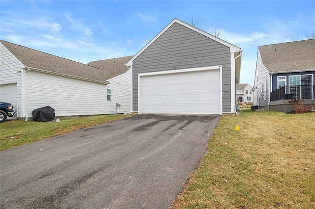 view of home's exterior featuring a garage and a lawn