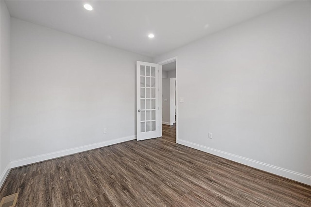 empty room featuring dark wood-type flooring