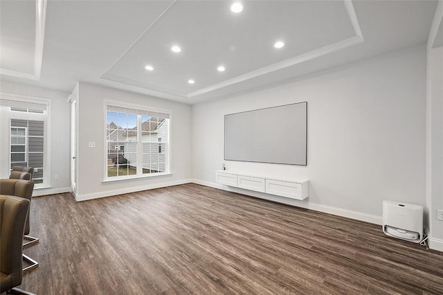 unfurnished living room with a raised ceiling and dark hardwood / wood-style flooring