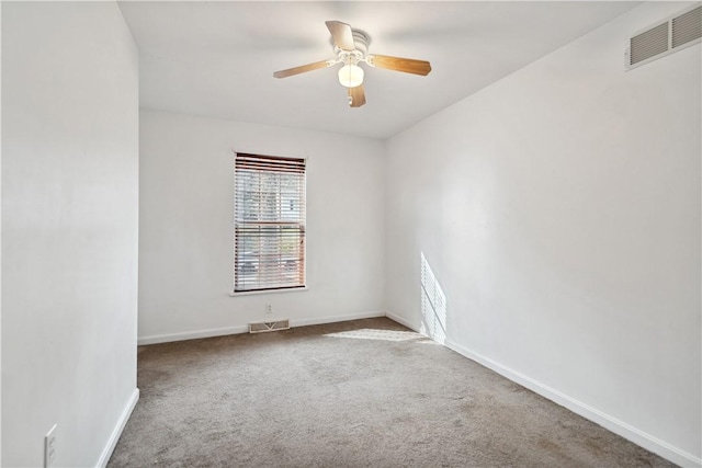 spare room with ceiling fan and carpet