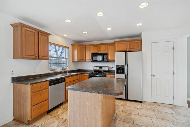 kitchen with stainless steel appliances, a center island, and sink