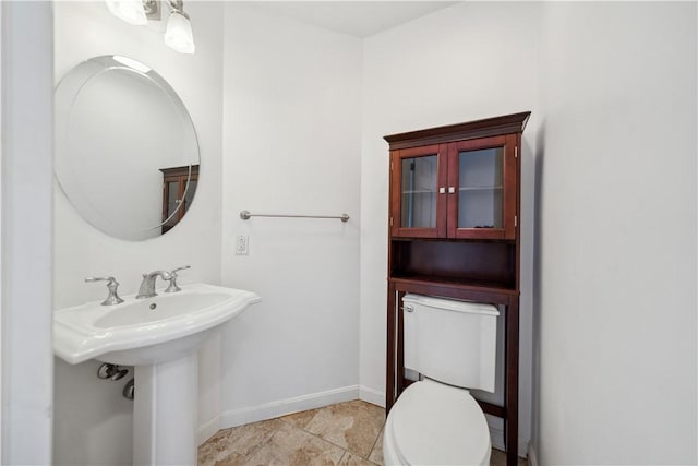 bathroom with tile patterned flooring, sink, and toilet