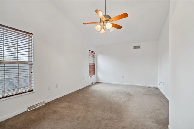 empty room with ceiling fan, high vaulted ceiling, and carpet