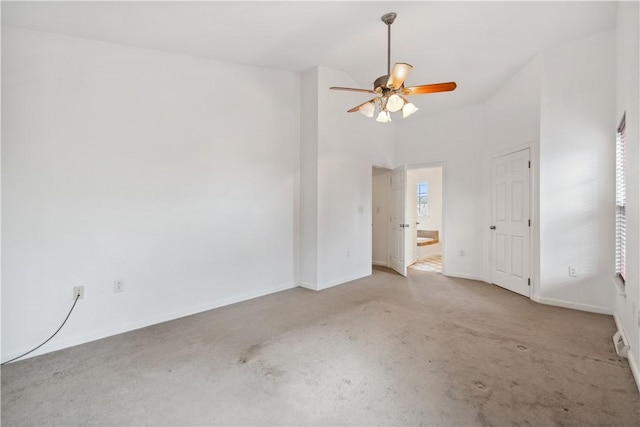 unfurnished room featuring a towering ceiling and ceiling fan