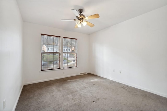 carpeted spare room featuring ceiling fan