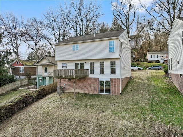 back of house featuring a wooden deck, central AC, and a lawn