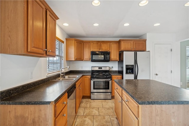 kitchen with appliances with stainless steel finishes, a center island, sink, and light tile patterned floors