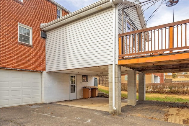 exterior space featuring a wooden deck and a garage